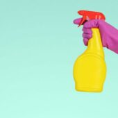 person holding yellow plastic spray bottle