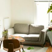 gray fabric loveseat near brown wooden table