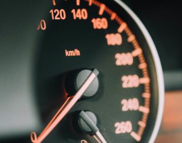 closeup photo of black analog speedometer