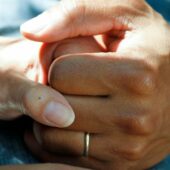 person wearing gold wedding band